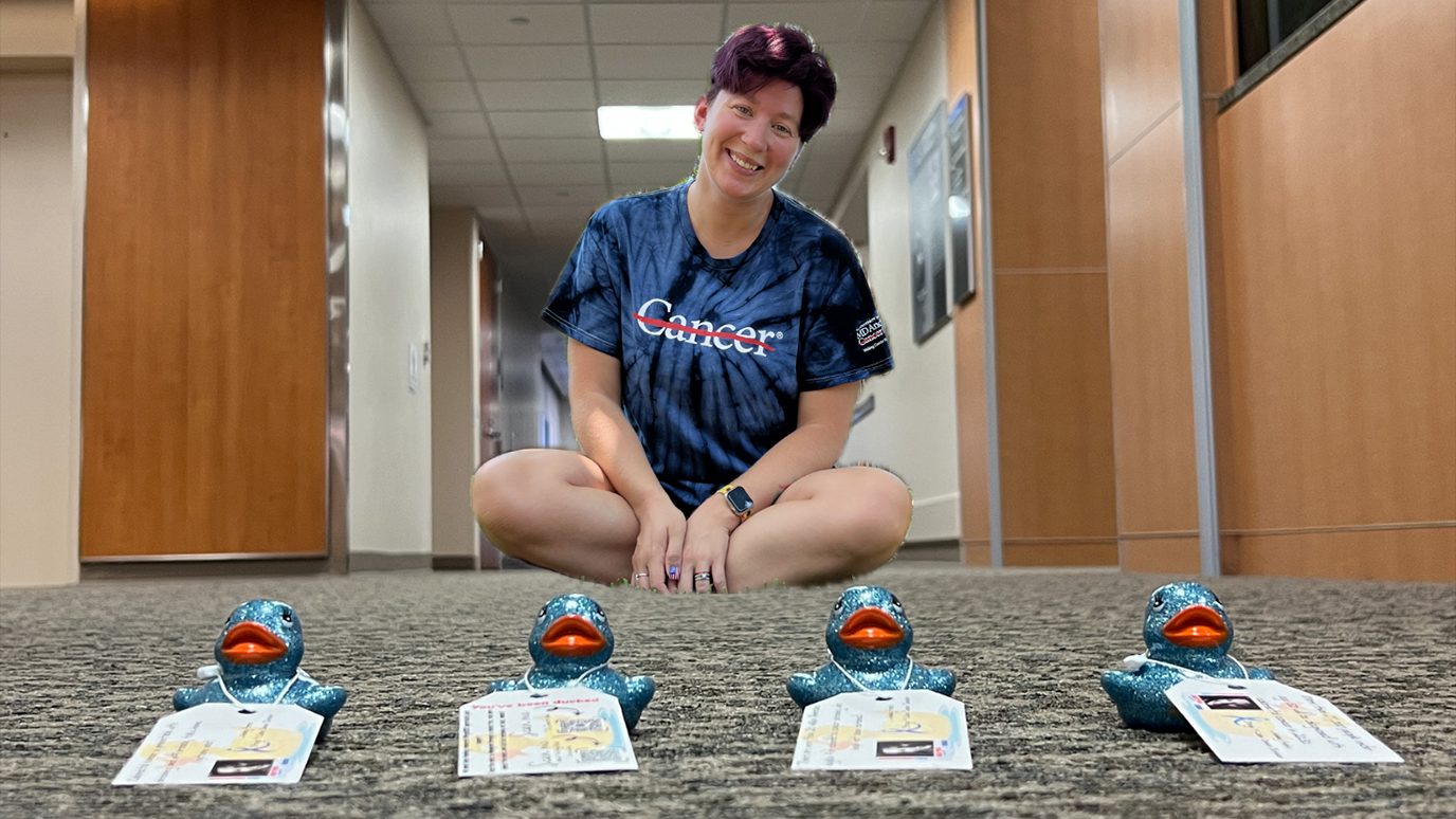 Colon cancer survivor Ashley Pedro, with four of her rubber ducks