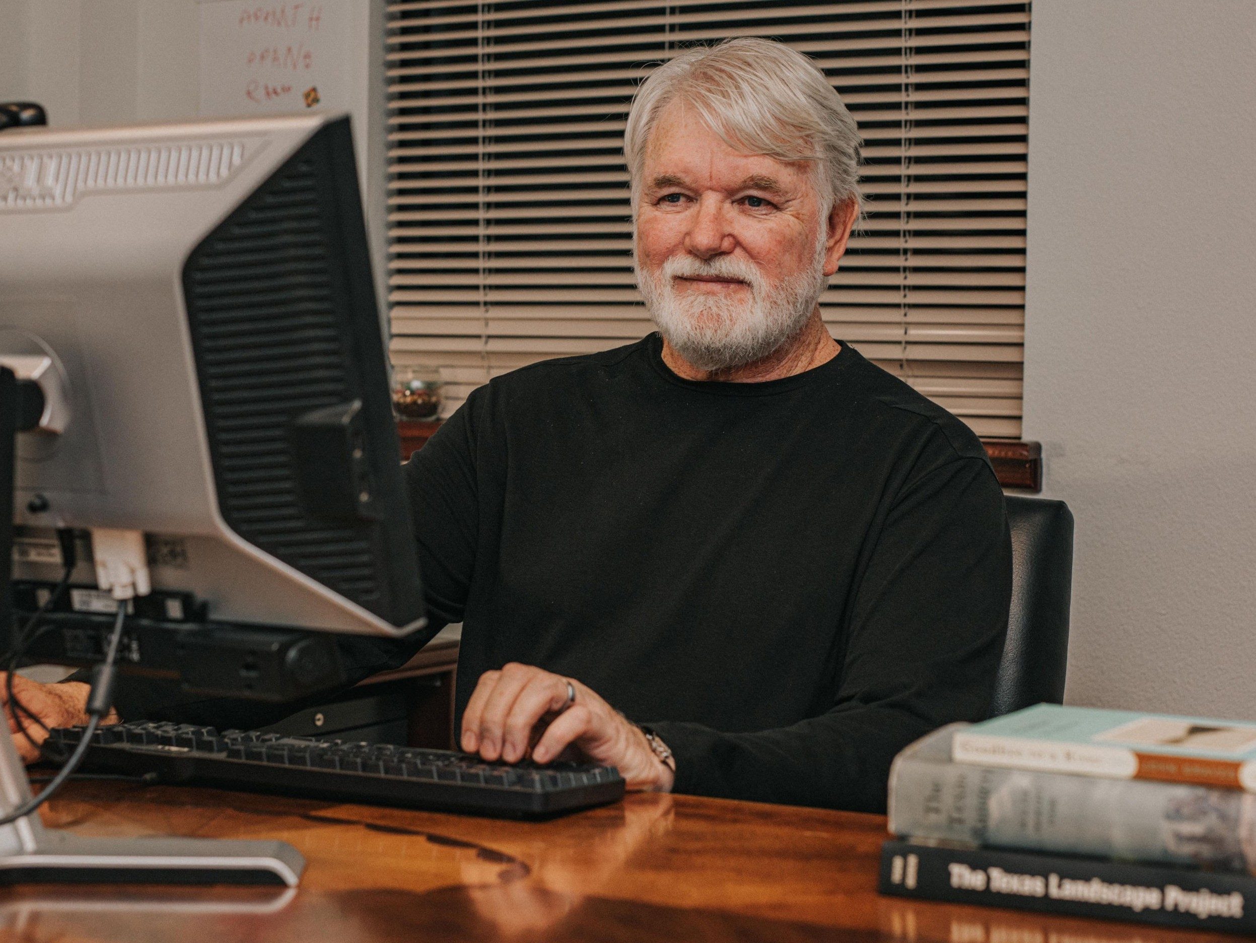 W.F. Strong sitting at his computer.