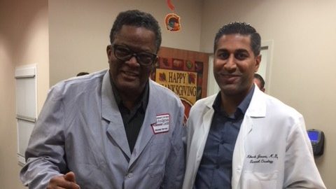 Caregiver to breast cancer survivor and volunteer Walter Ross (left) poses with Nikesh Jasani, M.D.