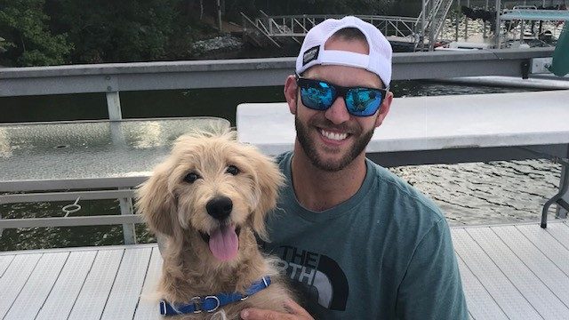 Melanoma survivor Nick Prochak, and his dog, Cody