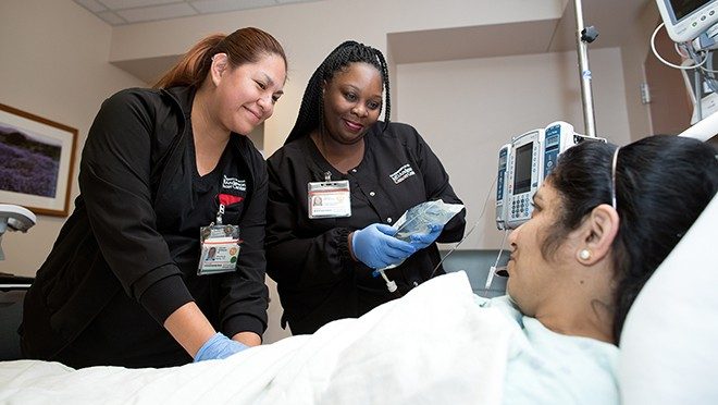 Jaquelin Velasquez, left, and Misha Hawkins perform the two-nurse verification process prior to infusing a patient with CAR T cells.