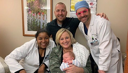 Sarcoma survivor Jessica Douglas with her son, husband, and Drs. David Adelman and Valerae O. Lewis