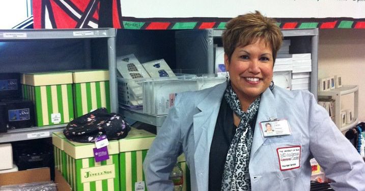 Salivary gland cancer survivor Lisa Torres posing for a photo while volunteering at MD Anderson