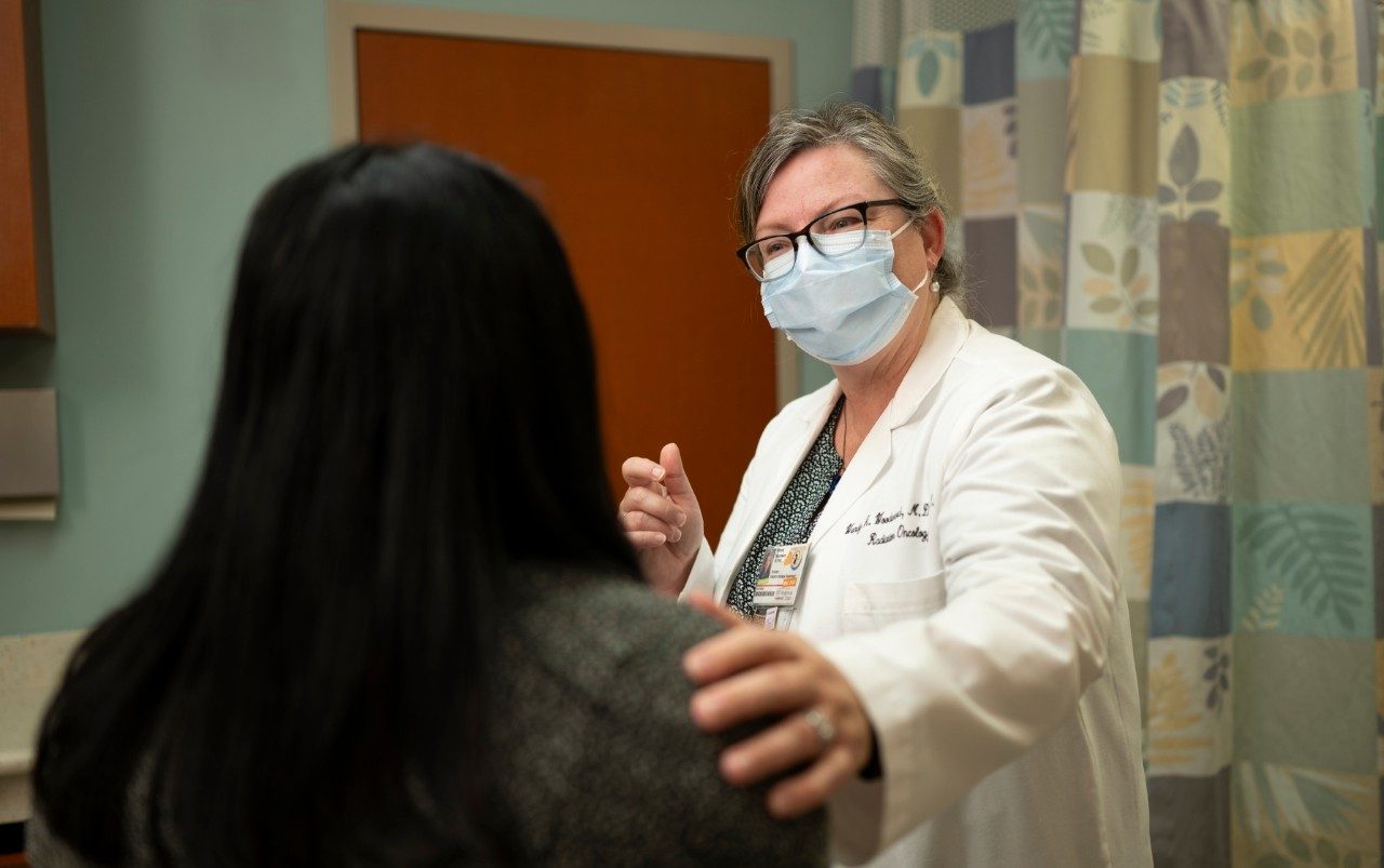 Wendy Woodward, M.D., Ph.D., speaks with a patient in the Morgan Welch Inflammatory Breast Cancer Clinic