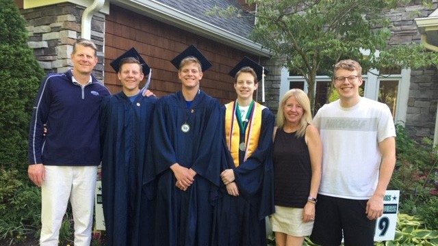 Melanoma survivor Michael Potthoff with his wife and sons before graduation