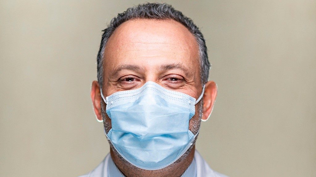 Chief Infection Control Officer Roy Chemaly, M.D., wears a medical-grade face mask in close-up portrait