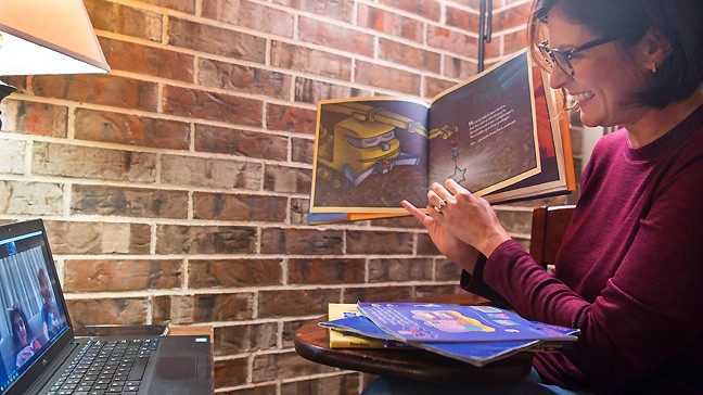 Laura Rodriguez, a teacher in MD Anderson's accredited K-12 school, reads bedtime stories to childhood cancer patient Adam Alshalabi and his twin sister, Celeen, on Zoom.