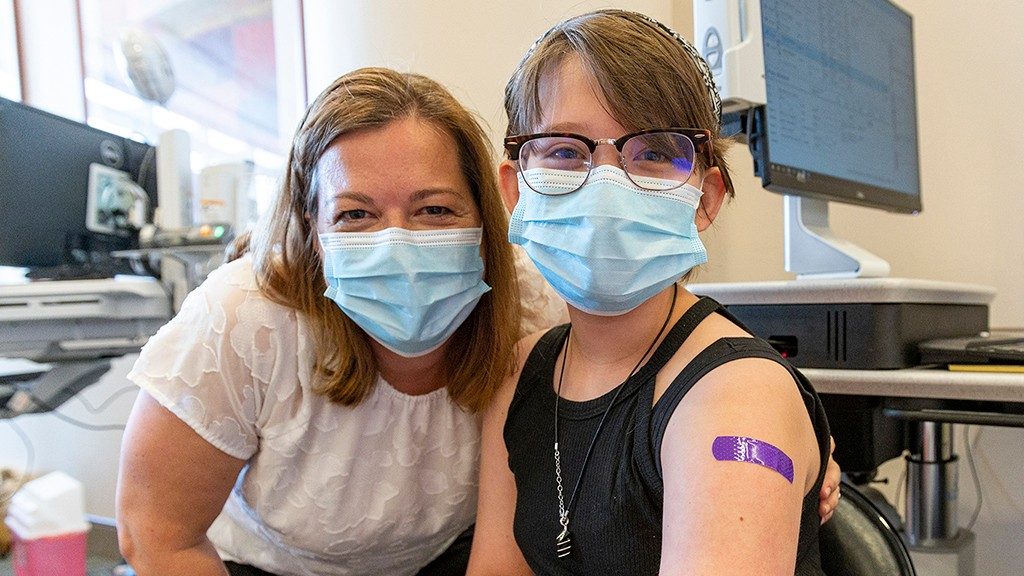 Ann Klopp, M.D., Ph.D., poses with her daughter Madeleine after she got vaccinated against COVID-19 at MD Anderson.