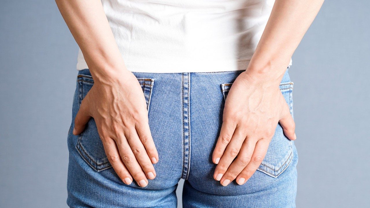 Close-up rear view of person in jeans with hands on back pockets