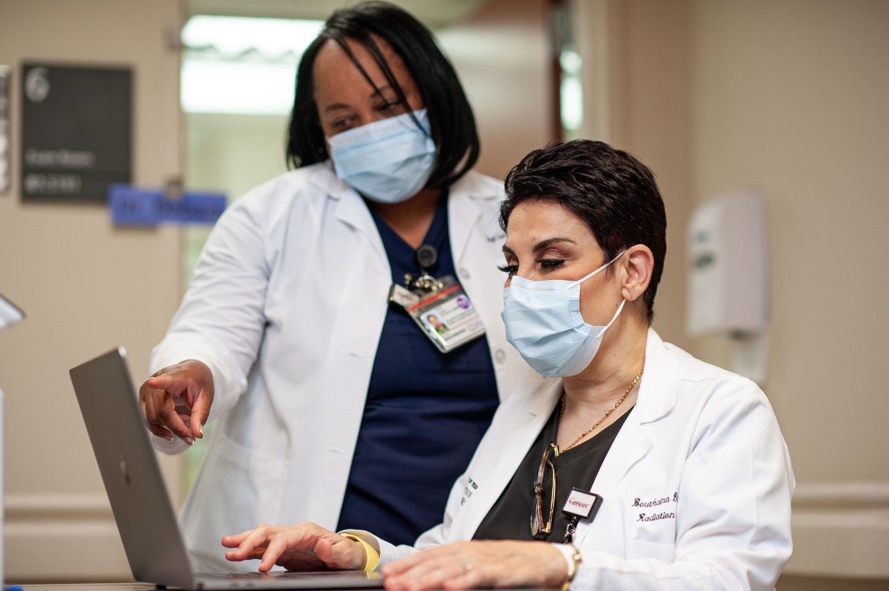 Radiation oncologist Bouthaina Dabaja, M.D., and Shryll Turner, advanced practice registered nurse, review scans.