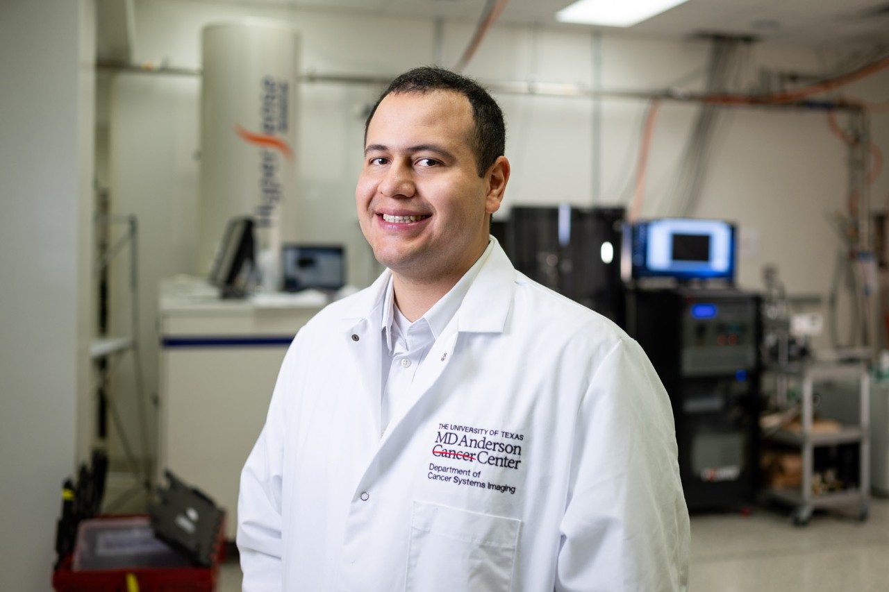 Graduate student Jose Enriquez in his white coat