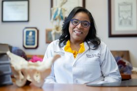 Dr. Valerae Lewis sitting at a desk in her office