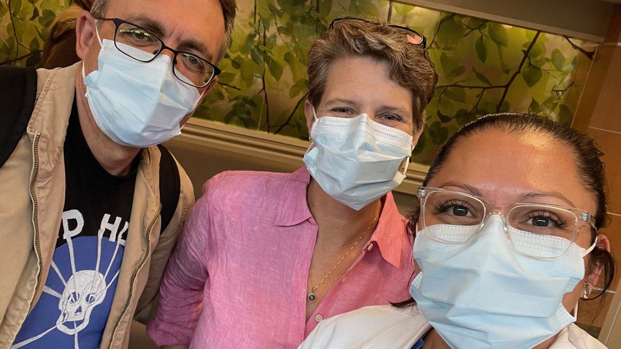 Pancreatic cancer survivor Helene Andrews-Polymenis (center) with her husband, Michael, and APRN Morgan Bruno