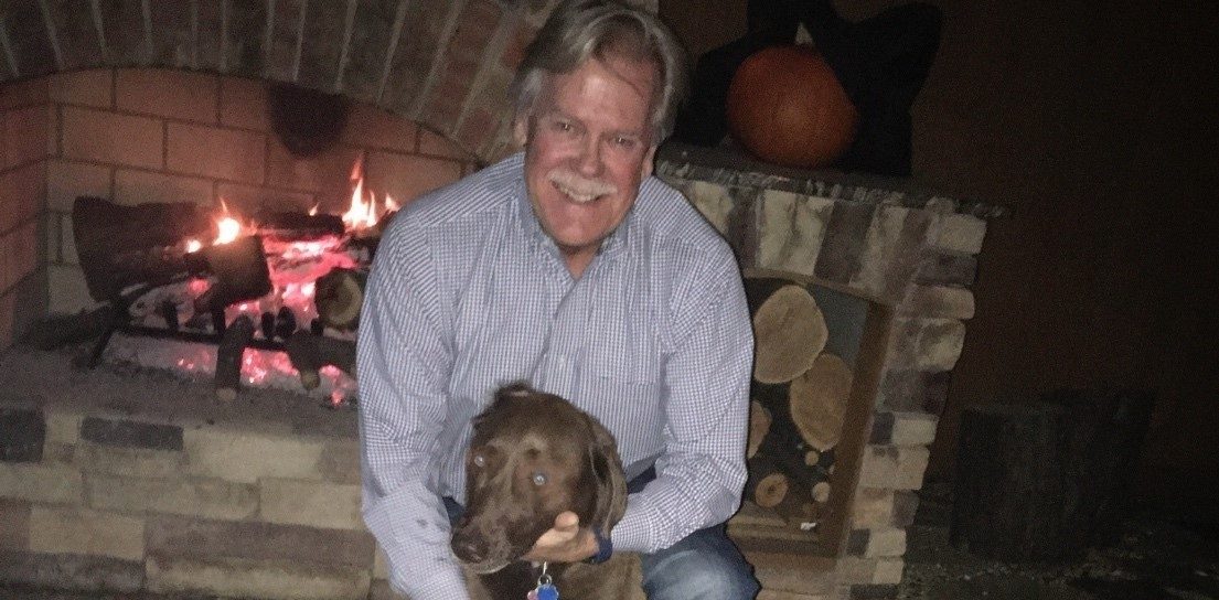 Keith Burchfield with his chocolate lab, Coco.