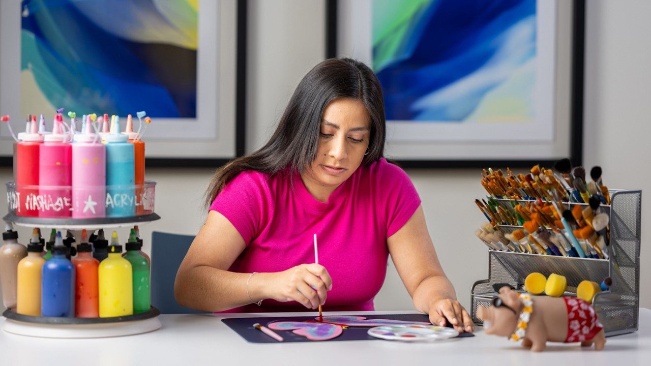 Leukemia caregiver Carley Exiga works on a project in the Art Space