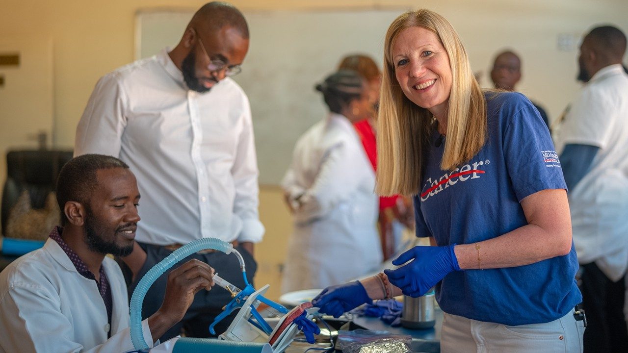 Kathleen Schmeler, M.D., trains health care providers at the Cancer Disease Hospital in Lusaka, Zambia, on performing excisional procedures for cervical cancer prevention using a LEEP machine.