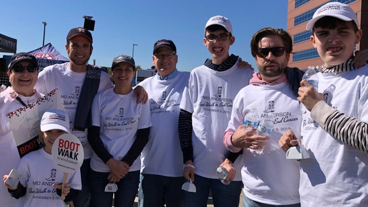 Leukemia survivor John Loper (fifth from left) poses with his family during the 2019 Boot Walk