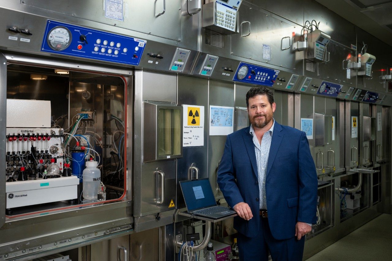 Dr. Manning posing in front of an open hot box in the lab