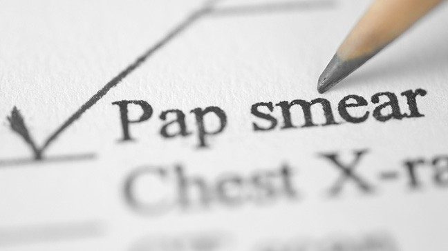 Pencil making a checkmark on a form next to the words 'Pap smear'