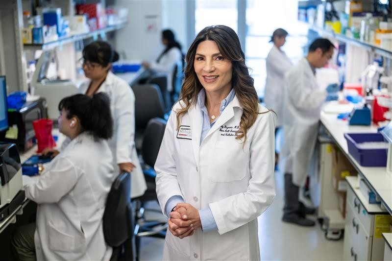 Dr. Katy Rezvani standing in a lab