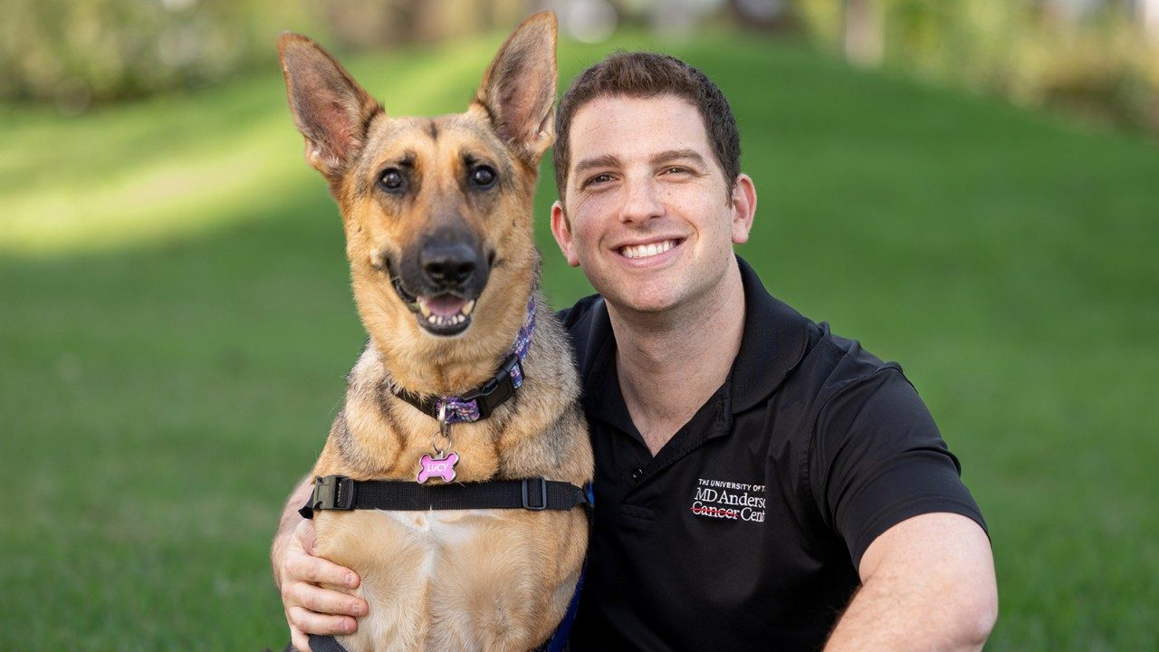 Adam Siegman with Lucy, one of the dogs in the BeWell Paws Program