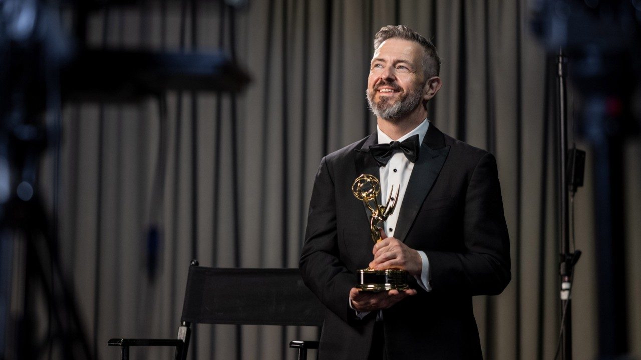 Alex King poses with the Lone Star Sports EMMY Award received for the video, Dusty Baker: A Living Legend.