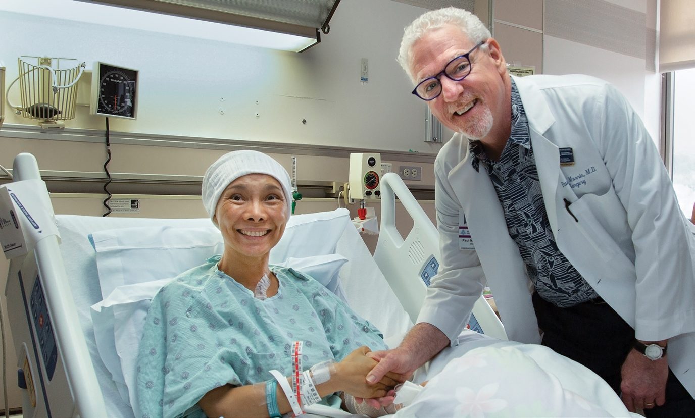 Paul Morris, M.D., chief of Surgery at The Queens Medical Center,with patient Shinkyong Chang