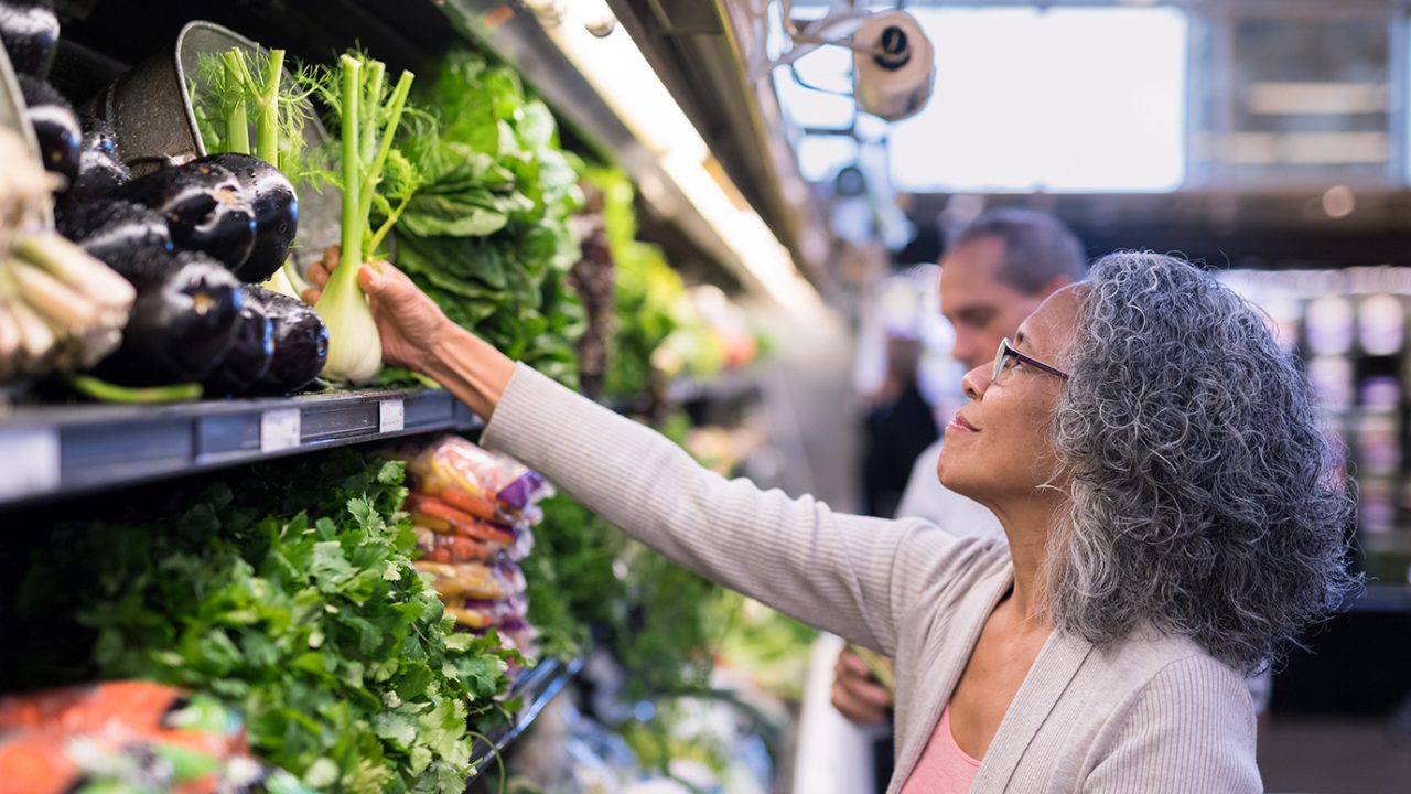 women selecting vegetables at the grocery store