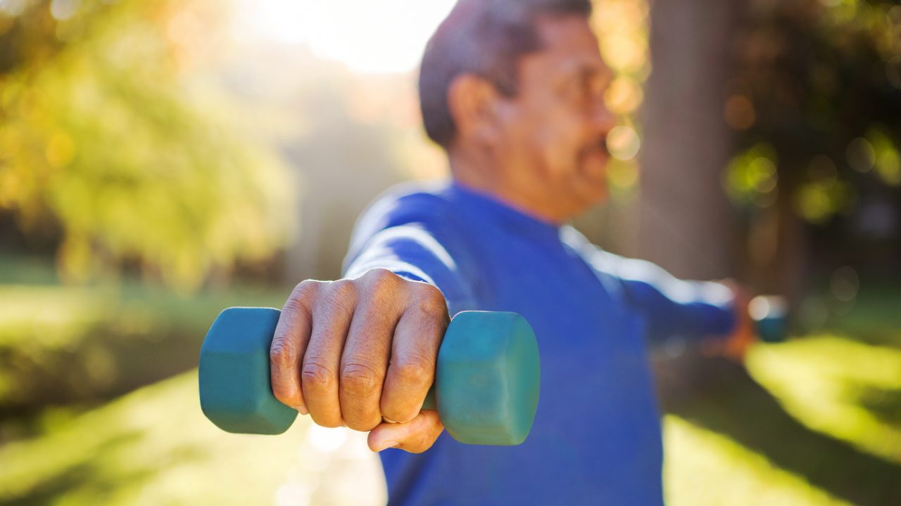 Man exercises with small weights